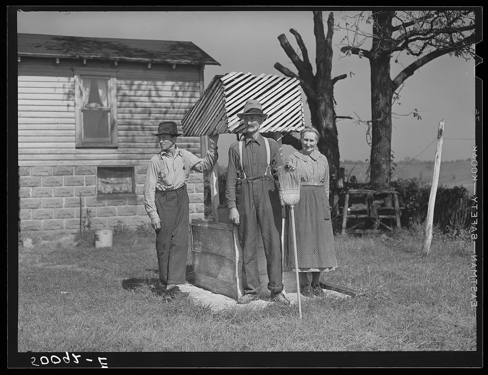 Farmer, his wife and son standing by well. West Virginia. Sourced from the Library of Congress.