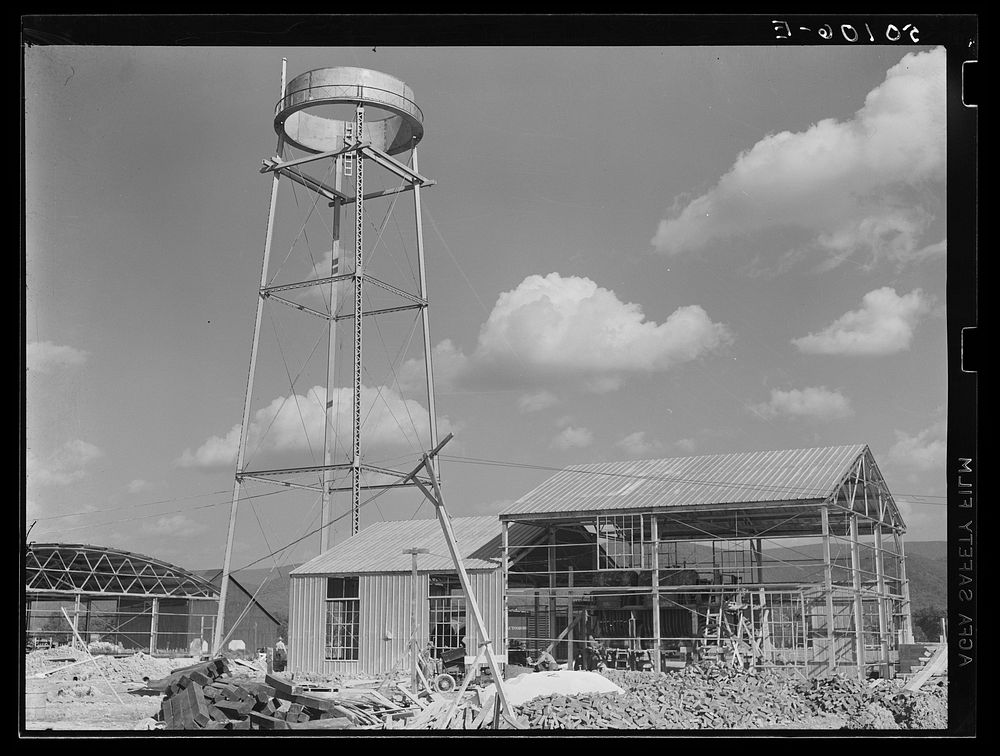 Construction, new community dimension woodworking factory for making furniture. Showing water tower. Tygart Valley, West…