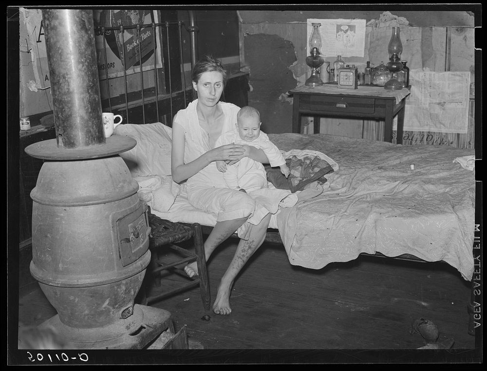 [Untitled photo, possibly related to: Wife and two children of unemployed mine worker. She has TB and syphilis. They are one…