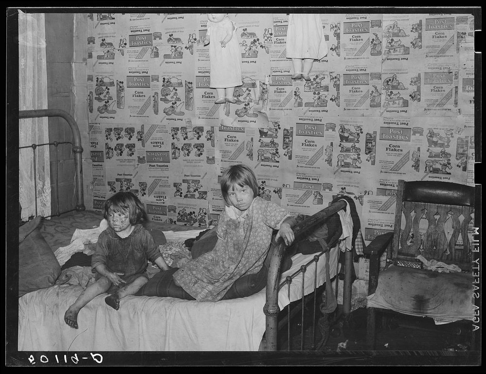 Children in bedroom of their home, Charleston, West Virginia. Their mother has TB. Father works on WPA (Works Progress…
