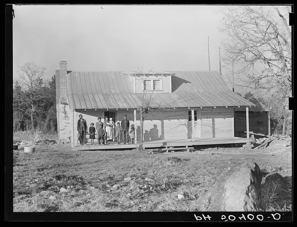  family (rehabilitation clients) on porch of new home they are building near Raleigh, North Carolina. Sourced from the…