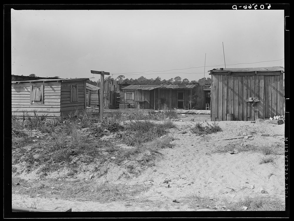 [Untitled photo, possibly related to:  sawmill workers' homes: no light, no privies, one outdoor water pump for whole camp.…