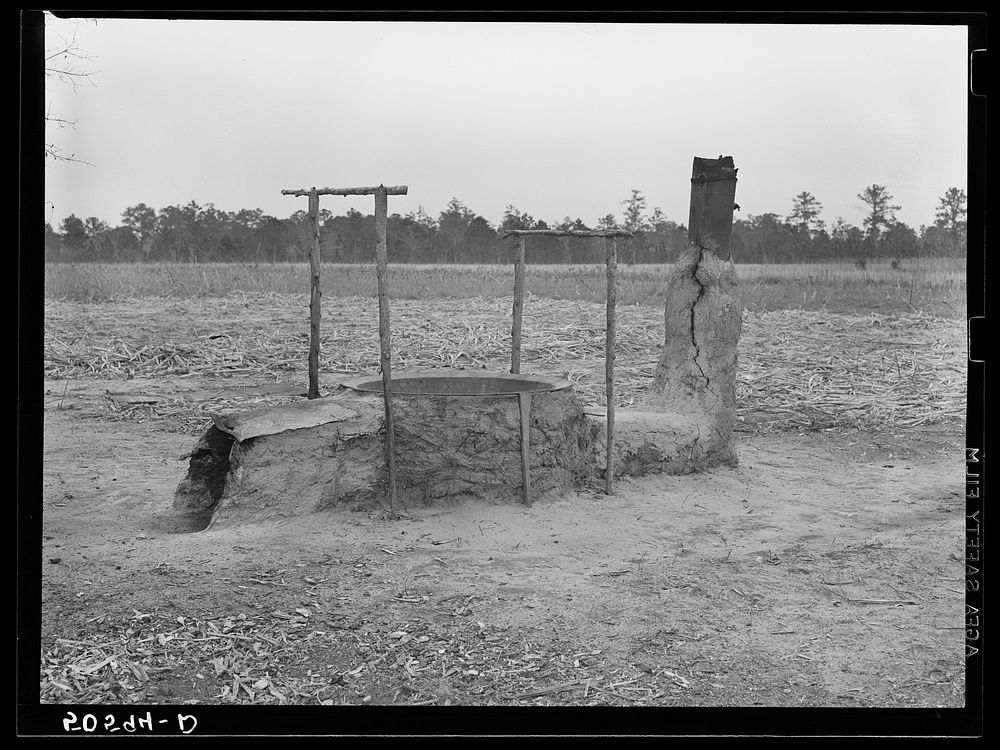 Mud and clay vat for cooking sorghum syrup in front yard of Indians home near Summerville, South Carolina. Sourced from the…