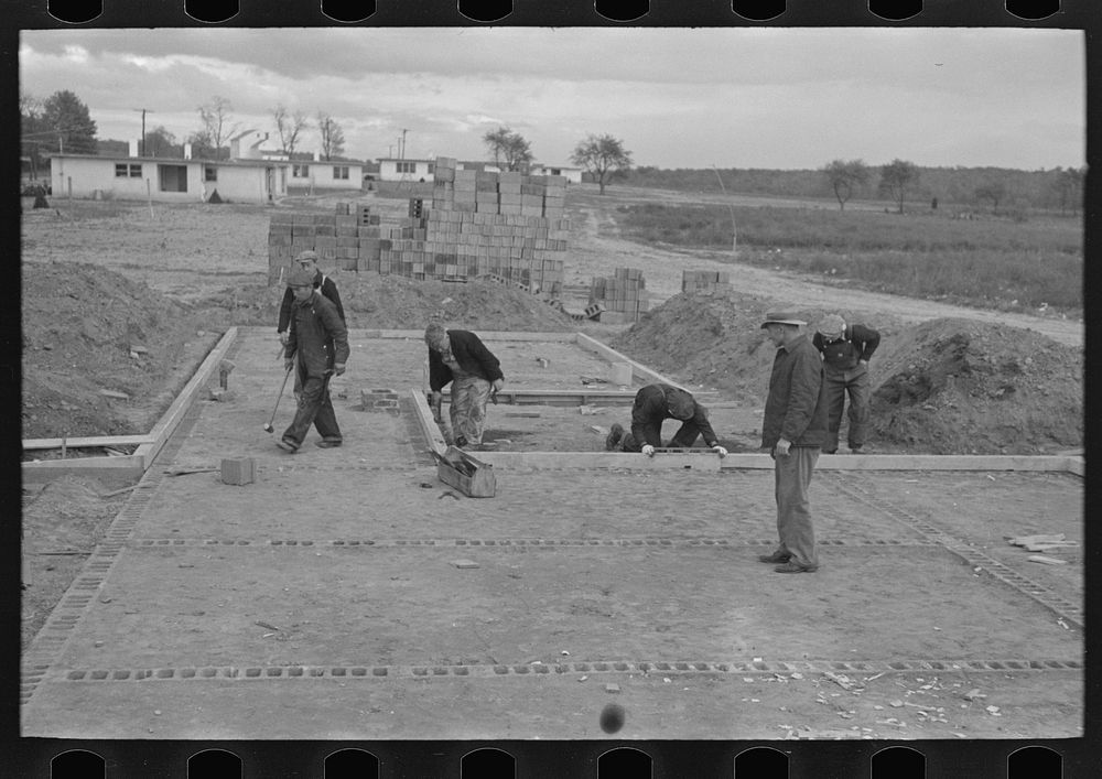 [Untitled photo, possibly related to: Laying foundation in construction of houses, Hightstown, New Jersey] by Russell Lee