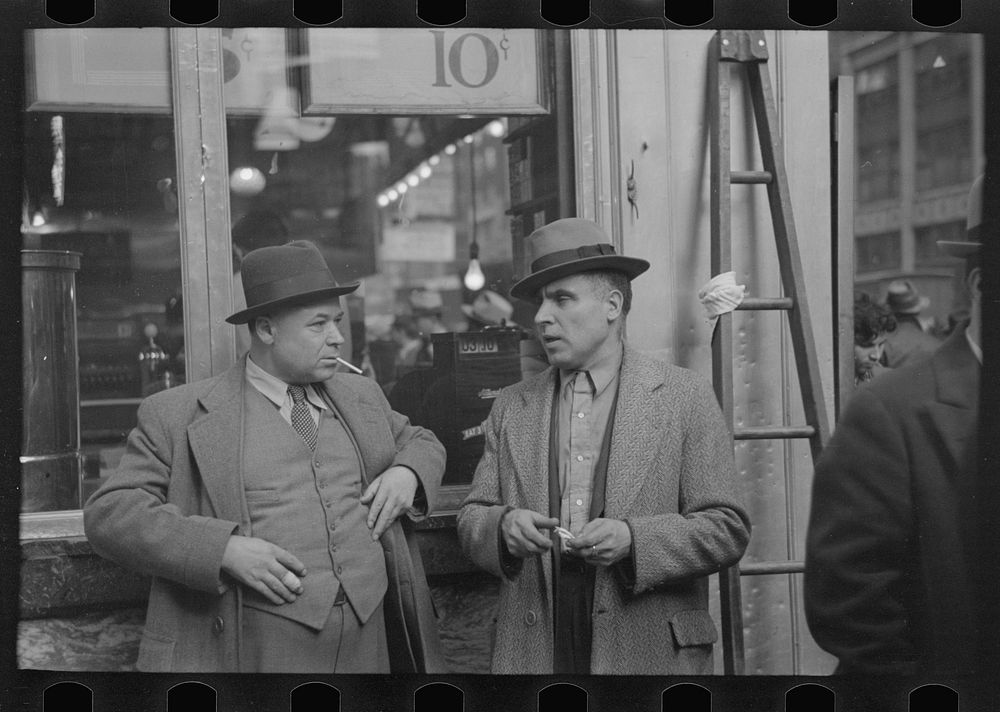 Two men in conversation, 7th Avenue near 38th Street, New York City by Russell Lee