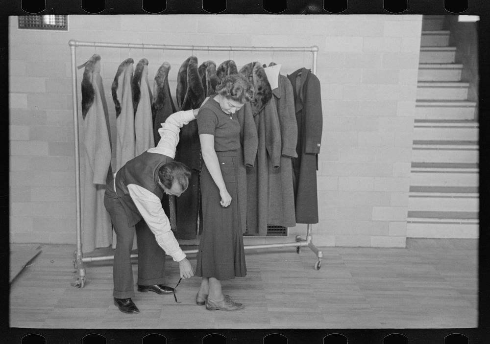 [Untitled photo, possibly related to: Measuring girl for a coat in cooperative garment factory at Jersey Homesteads…
