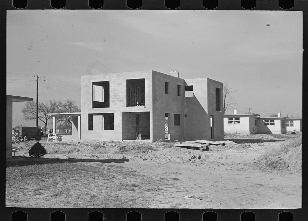 [Untitled photo, possibly related to: New type of two-story house under construction. Stucco coat has just been applied…