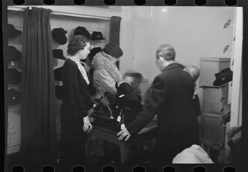 [Untitled photo, possibly related to: Model trying on hat for a buyer, New York City showroom, Jersey Homesteads…