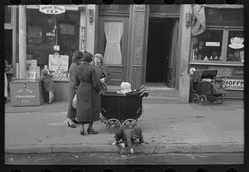 Mothers talking together and child playing in the gutter, 139th Street just east of St. Anne's Avenue, Bronx, New York by…