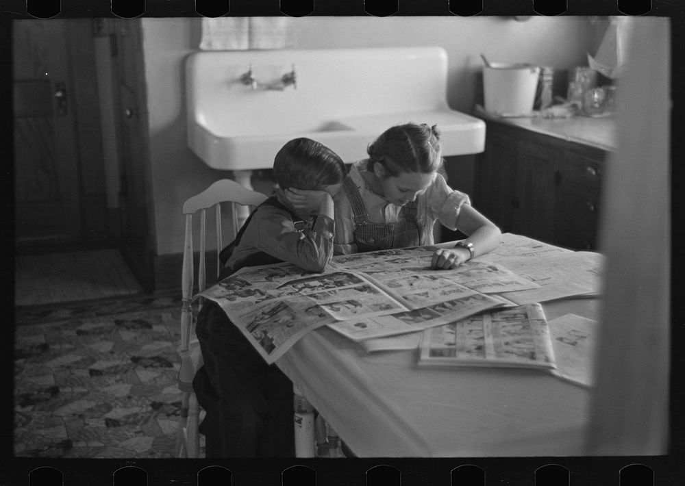 [Untitled photo, possibly related to: Children reading Sunday papers, Rustan brothers' farm near Dickens, Iowa. Note…