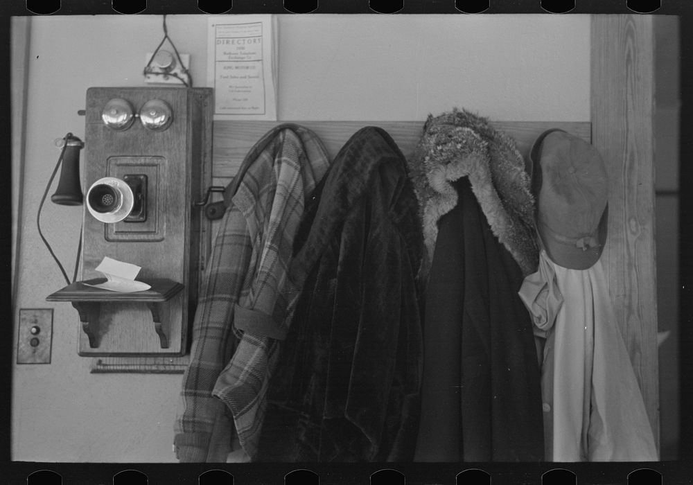 [Untitled photo, possibly related to: Garments hanging near telephone in Rustan brothers' farm near Dickens, Iowa] by…
