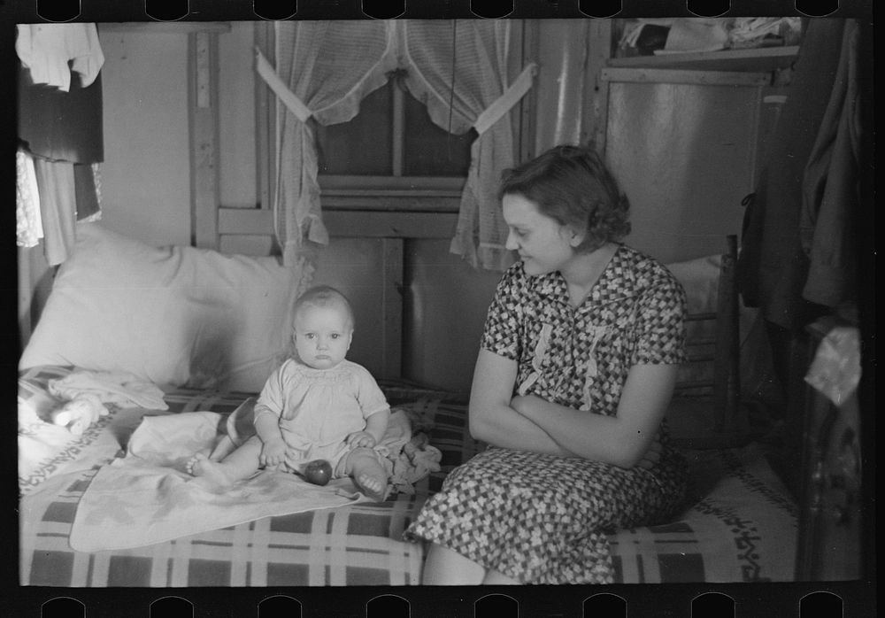 Mrs. Charles Benning and baby in their shack home at Shantytown, Spencer, Iowa by Russell Lee