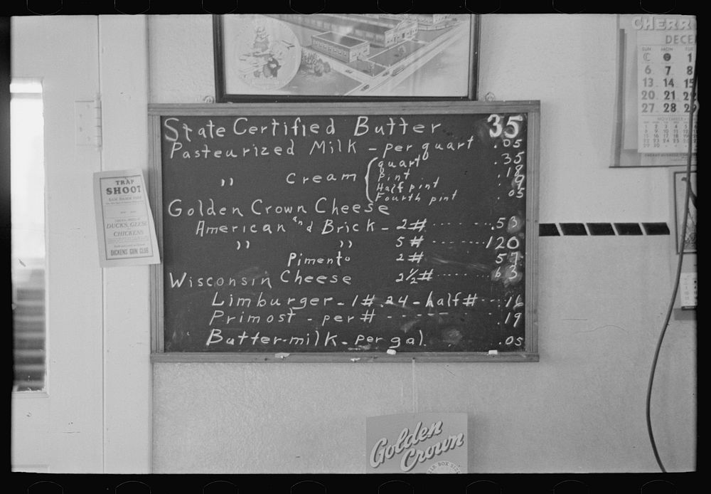 Sign showing scale of prices (retail) at farmer cooperative creamery, Ruthven, Iowa. Note the low prices by Russell Lee