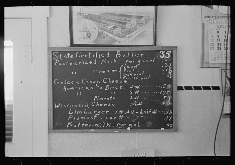 [Untitled photo, possibly related to: Sign showing scale of prices (retail) at farmer cooperative creamery, Ruthven, Iowa.…