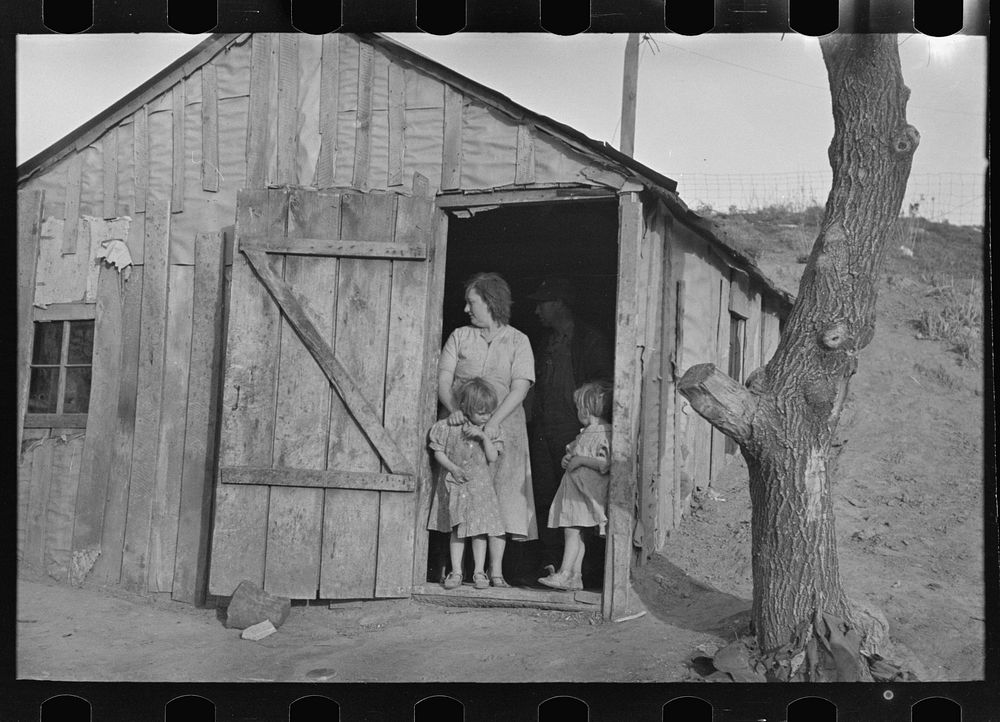 Mrs. Earl Pauley and some of her children in doorway of farm home near Smithland, Iowa. They are tenant farmers by Russell…