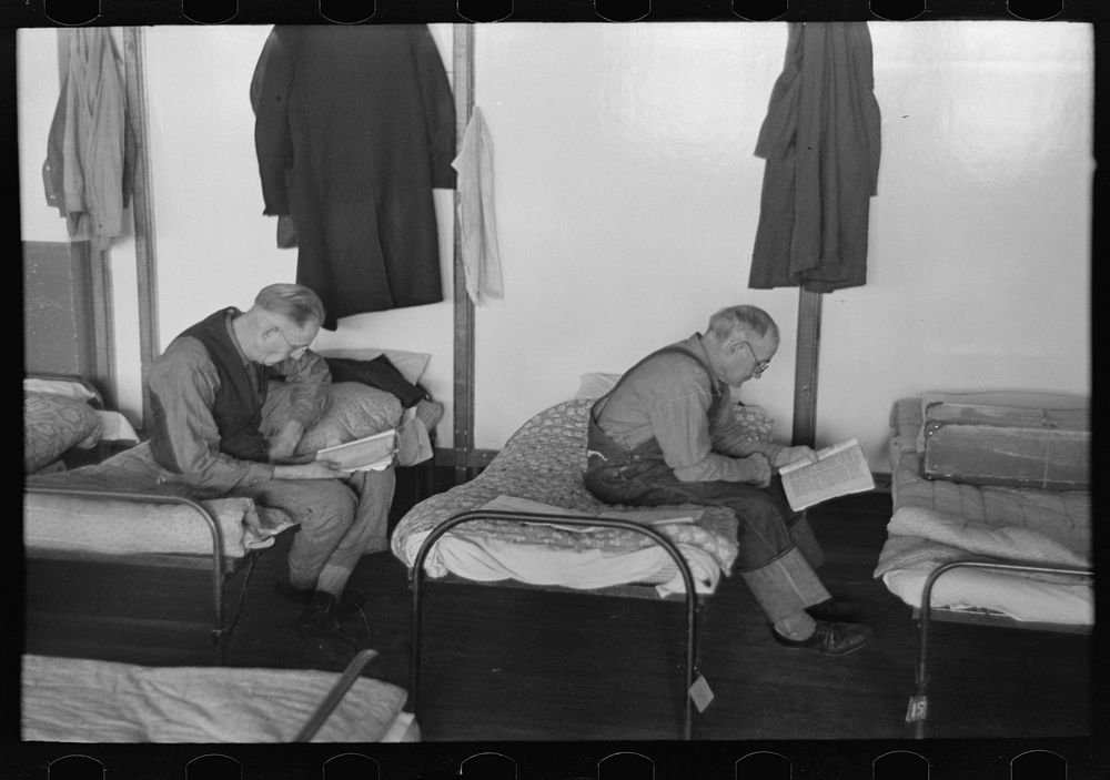 [Untitled photo, possibly related to: Men reading in dormitory, homeless men's bureau, Sioux City, Iowa] by Russell Lee