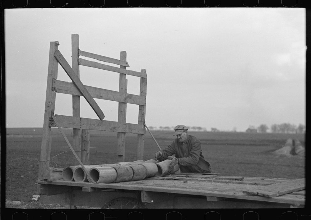 Tip Estes loading tile on a wagon, Fowler, Indiana by Russell Lee