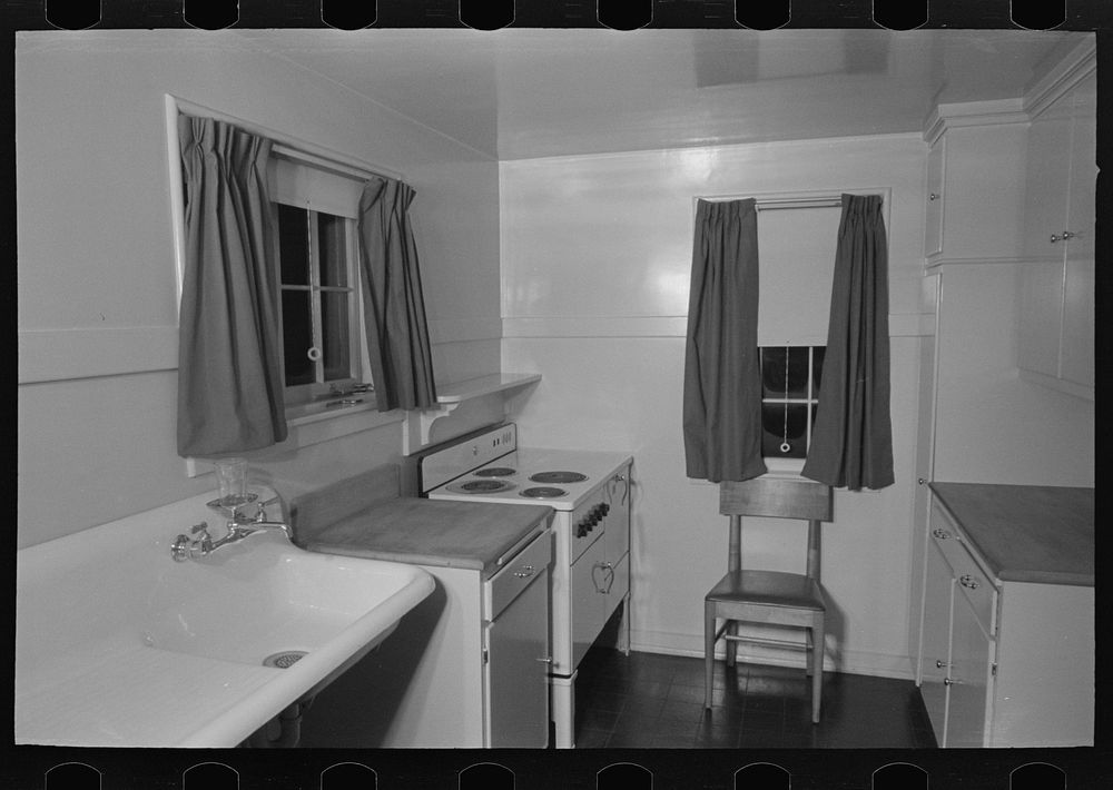 Sink, refrigerator and stove in the kitchen of the model house at Greendale, Wisconsin by Russell Lee