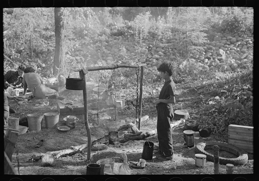 Indian boy and cooking arrangement, blueberry camp near Little Fork, Minnesota by Russell Lee