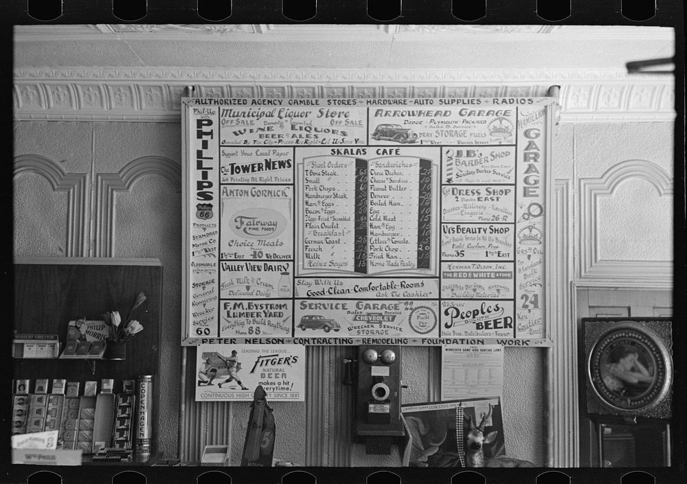 Bill of fare, advertising board and goods in restaurant, Tower, Minnesota by Russell Lee
