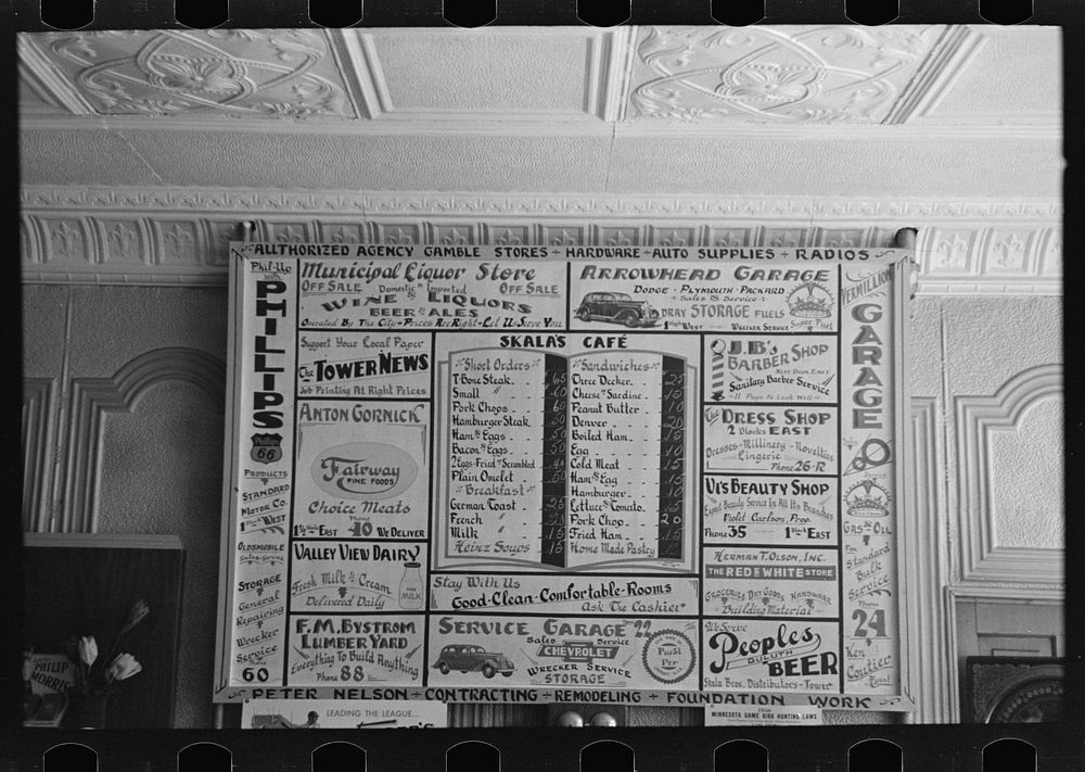 Bill of fare, advertising board and goods in restaurant, Tower, Minnesota by Russell Lee