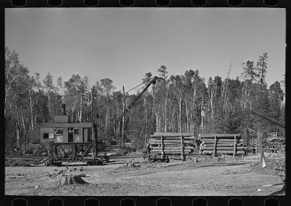 Loading device moving railroad cars full of timber at camp near Effie, Minnesota by Russell Lee