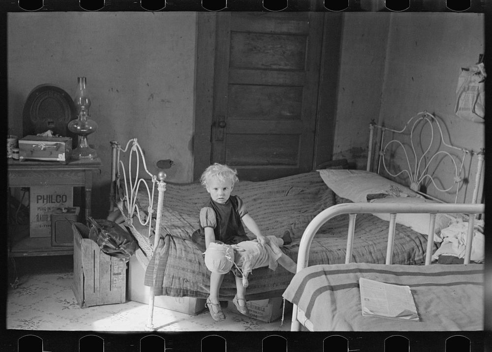 Child of Edwin Gorder in farmhouse bedroom, Williams County, North Dakota by Russell Lee