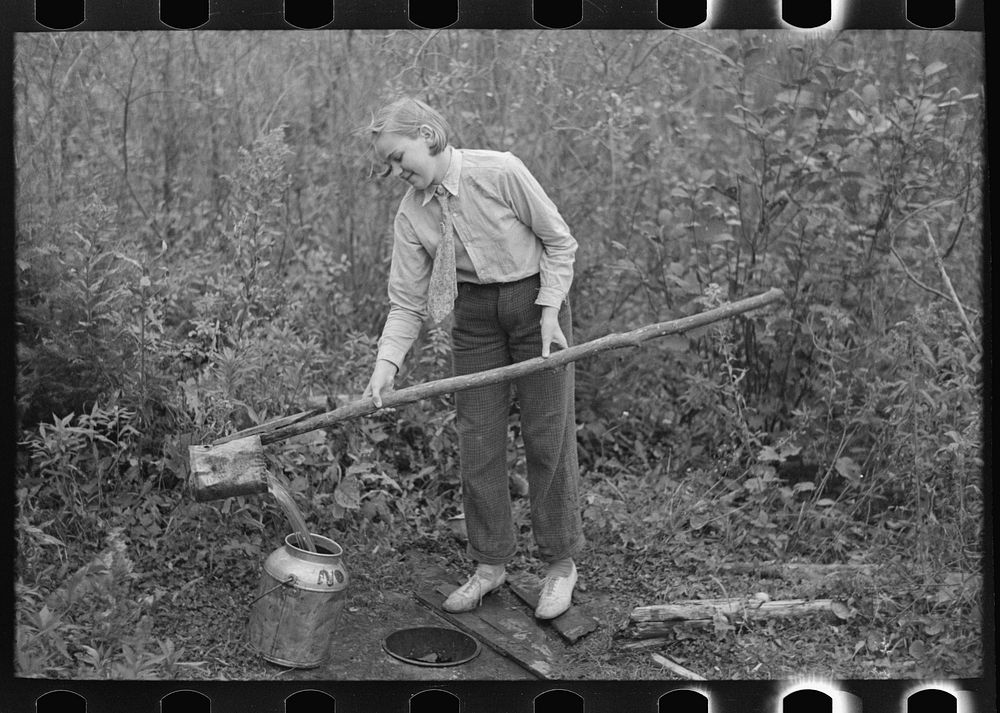 [Untitled photo, possibly related to: Filling can with water from shallow well on farm near Northome, Minnesota] by Russell…