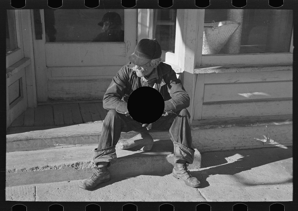 [Untitled photo, possibly related to: Arnegard, McKenzie County, North Dakota. Old man sitting on a store step] by Russell…