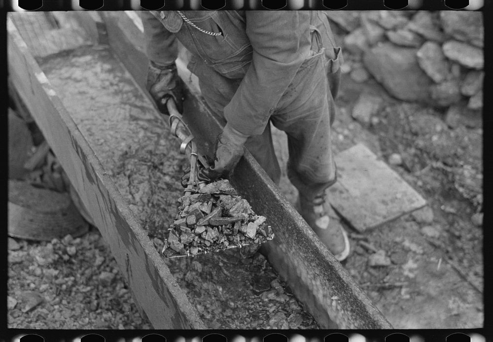 [Untitled photo, possibly related to: Gold miner working in sluice box, Two Bit Creek, South Dakota] by Russell Lee