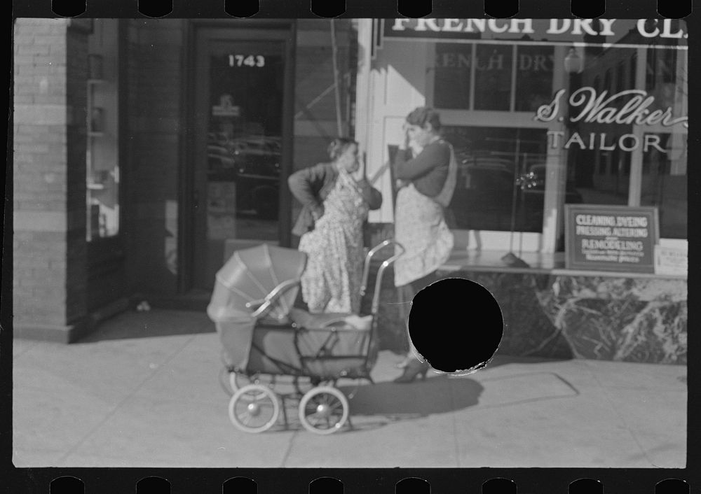 [Untitled photo, possibly related to: Women with baby carriage, L Street, Washington, D.C.] by Russell Lee