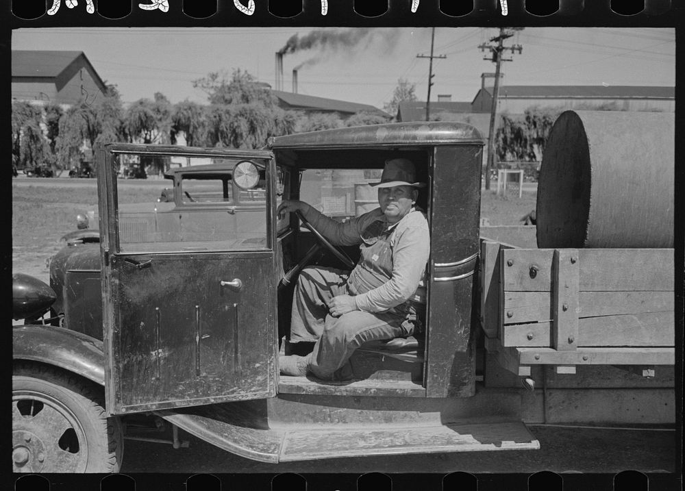 Farmer in cab of truck at liquid feed loading station at Owensboro, Kentucky by Russell Lee