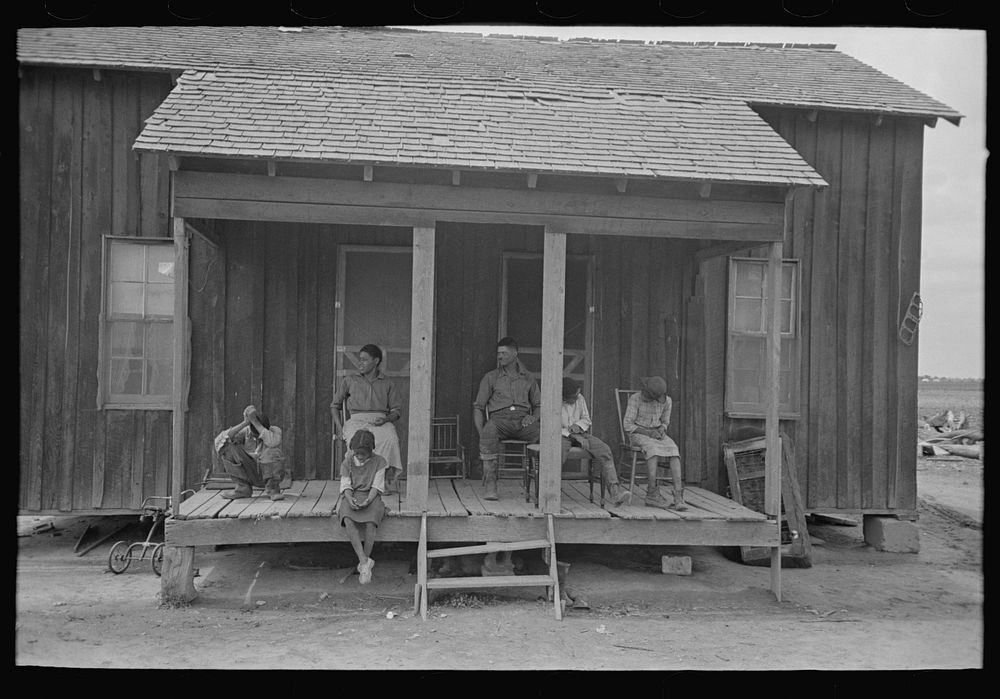 Family of FSA (Farm Security Administration) client farmer sharecropper on porch of old home, Southeast Missouri Farms by…