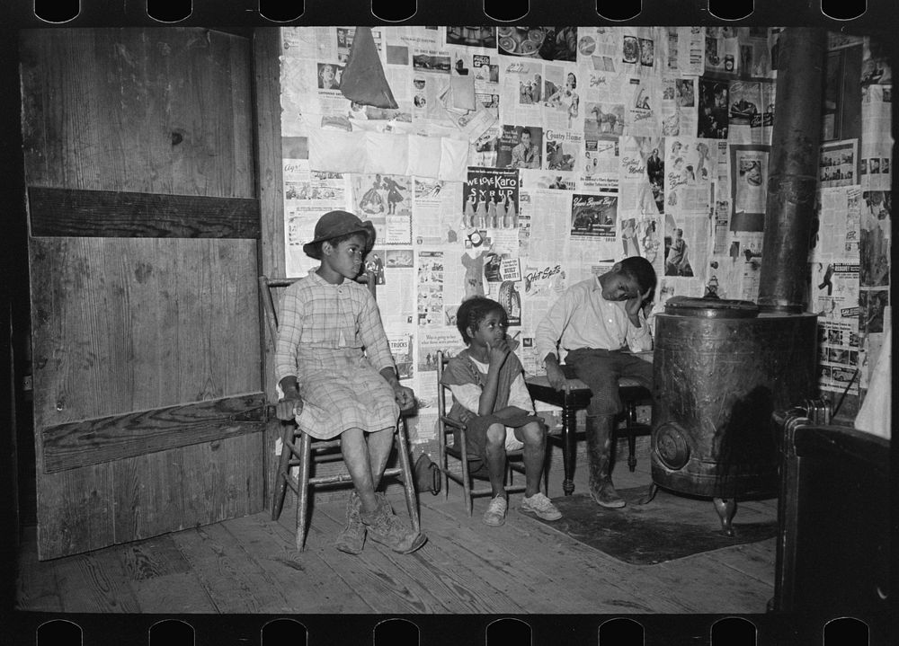 Southeast Missouri Farms. Children sitting in living room of shack home by Russell Lee