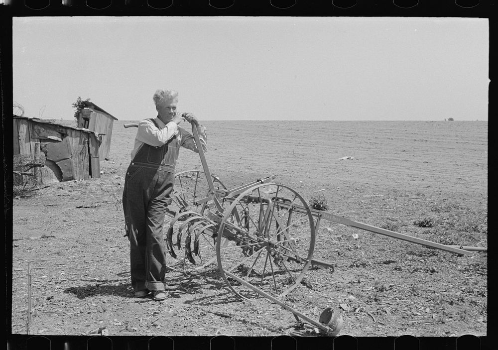 FSA (Farm Security Administration) client leaning on handle of machine for cultivating bought with loans made available to…