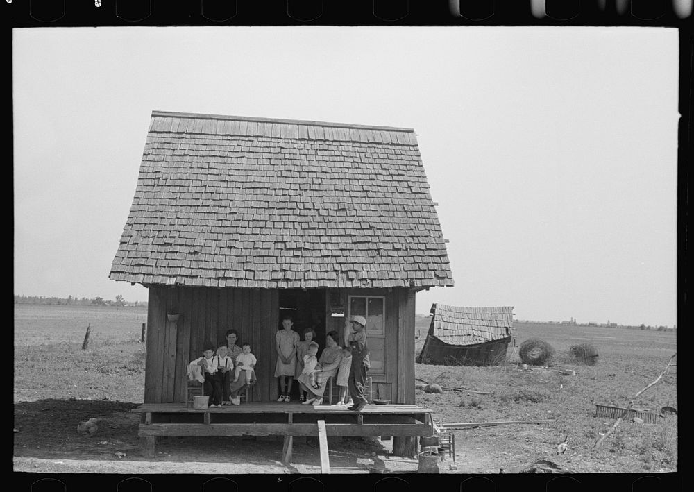Sharecropper family on front porch of cabin, New Madrid County, Missouri by Russell Lee