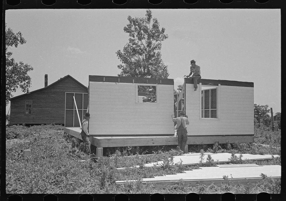 [Untitled photo, possibly related to: Southeast Missouri Farms Project. House erection. Roofing over shingle lath with wood…