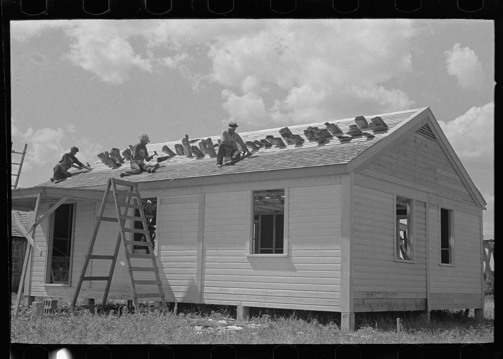 [Untitled photo, possibly related to: Southeast Missouri Farms Project. House erection. Shingling crew at work on roof.…