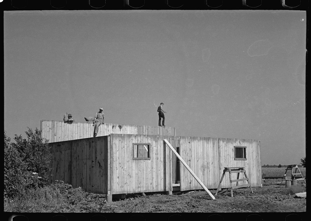 Erecting panels of prefabricated barn, Southeast Missouri Farms by Russell Lee
