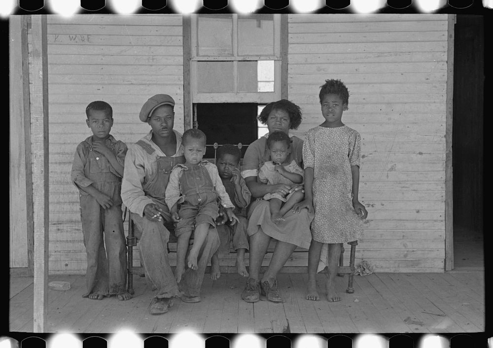 Family of FSA (Farm Security Administration) client, former sharecropper, on porch of old shack home. New Madrid County…