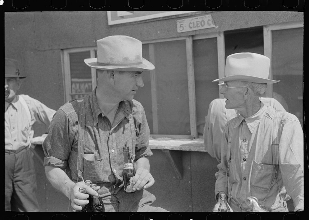 Farmers at auction with soft drinks, Sikeston, Missouri by Russell Lee