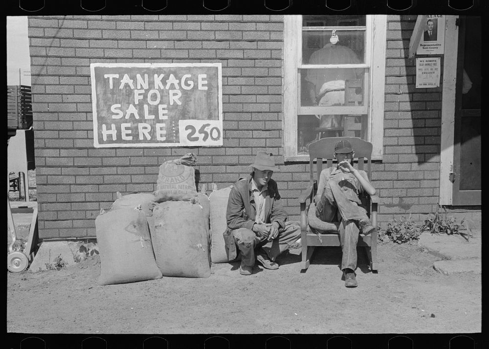 Farmers' sons sitting in front of auction pavilion, Sikeston, Missouri by Russell Lee