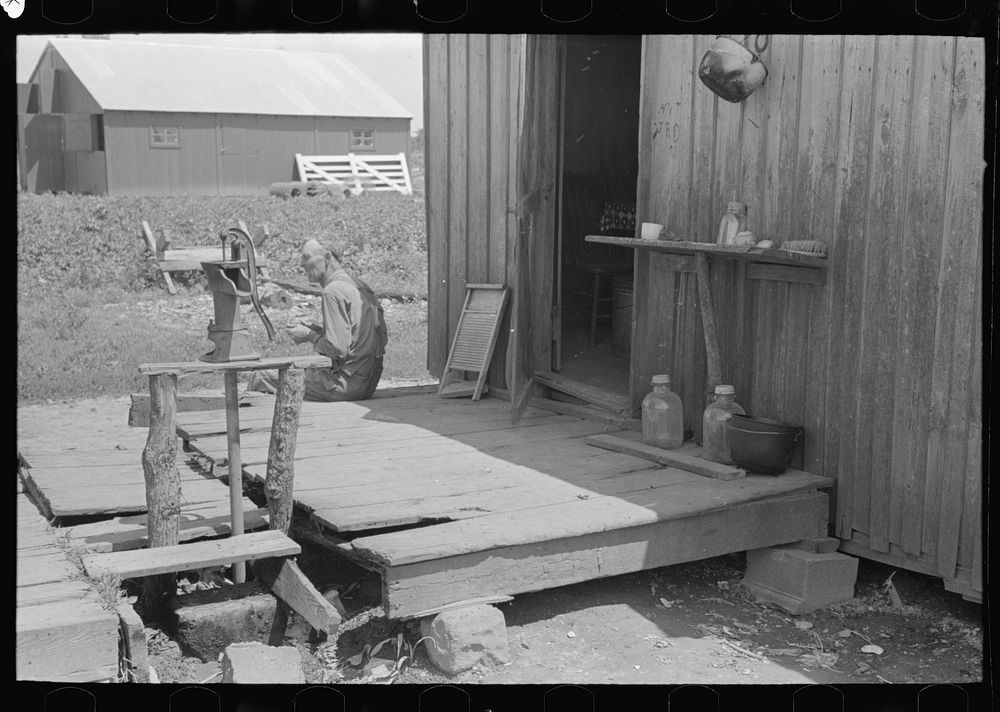 FSA (Farm Security Administration) client, former sharecropper, on porch of shack home, Southeast Missouri Farms by Russell…