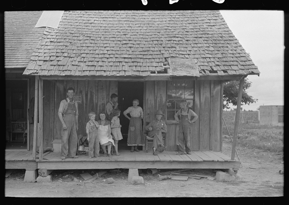 [Untitled photo, possibly related to: Sharecropper family on front porch of cabin, Southeast Missouri Farms] by Russell Lee