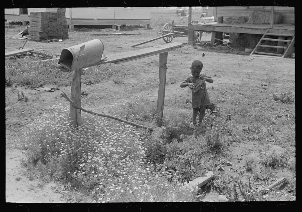 Child playing with toy near mailbox, Southeast Missouri Farms by Russell Lee