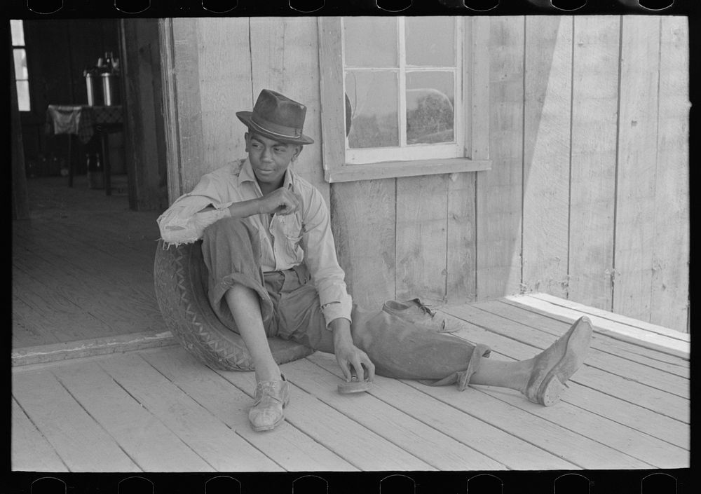 Son of sharecropper on front porch of shack home, Southeast Missouri Farms by Russell Lee