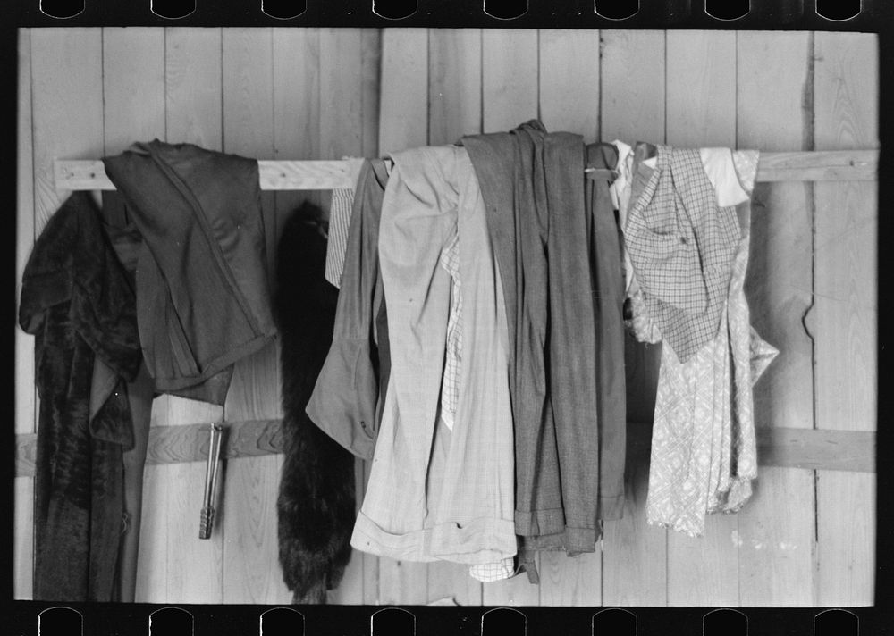 Southeast Missouri Farms. Clothes hanging on improvised hangers in sharecropper's cabin by Russell Lee