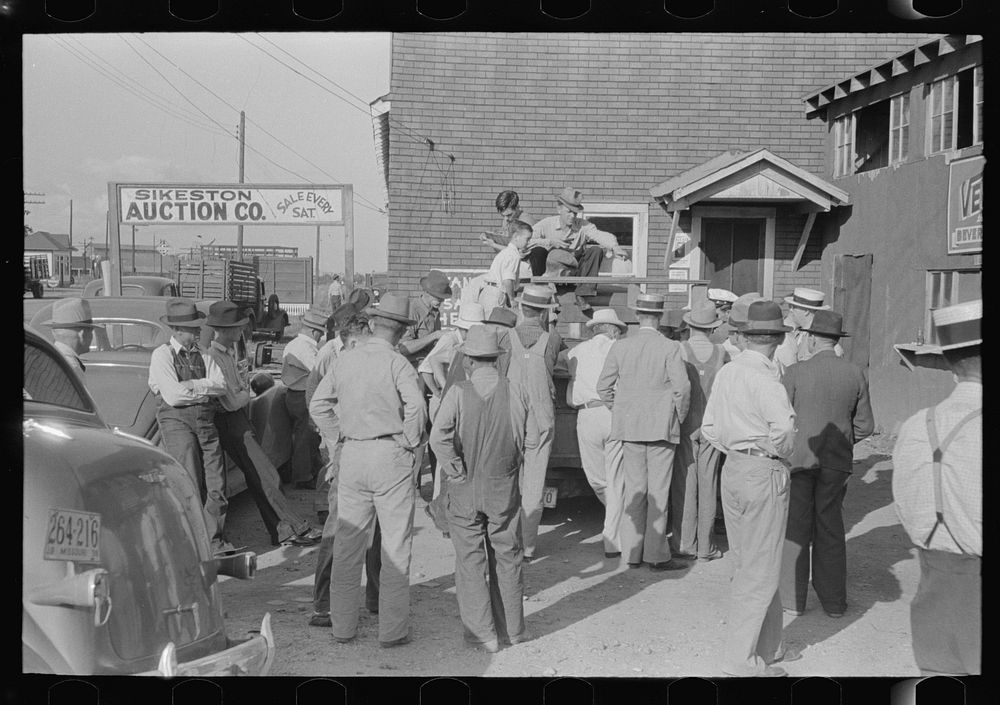 Group of farmers at peach auction, Sikeston, Missouri by Russell Lee