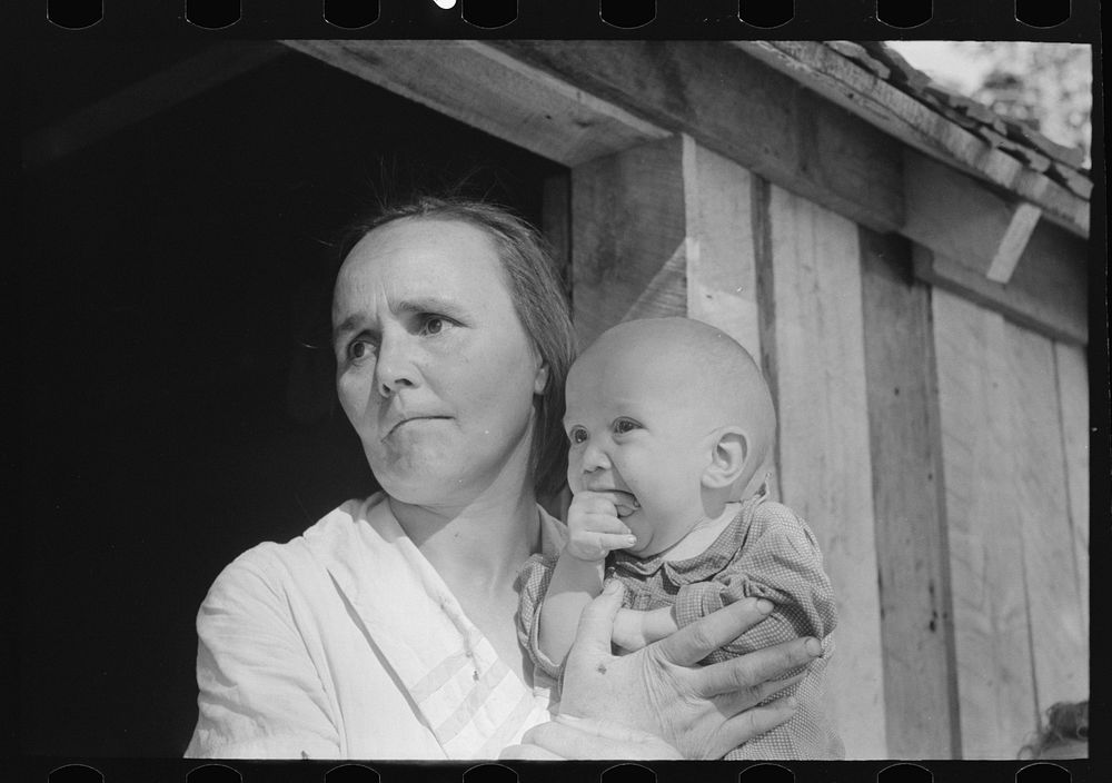 Wife and child of sharecropper, cut-over farmer in bottoms of Mississippi River by Russell Lee