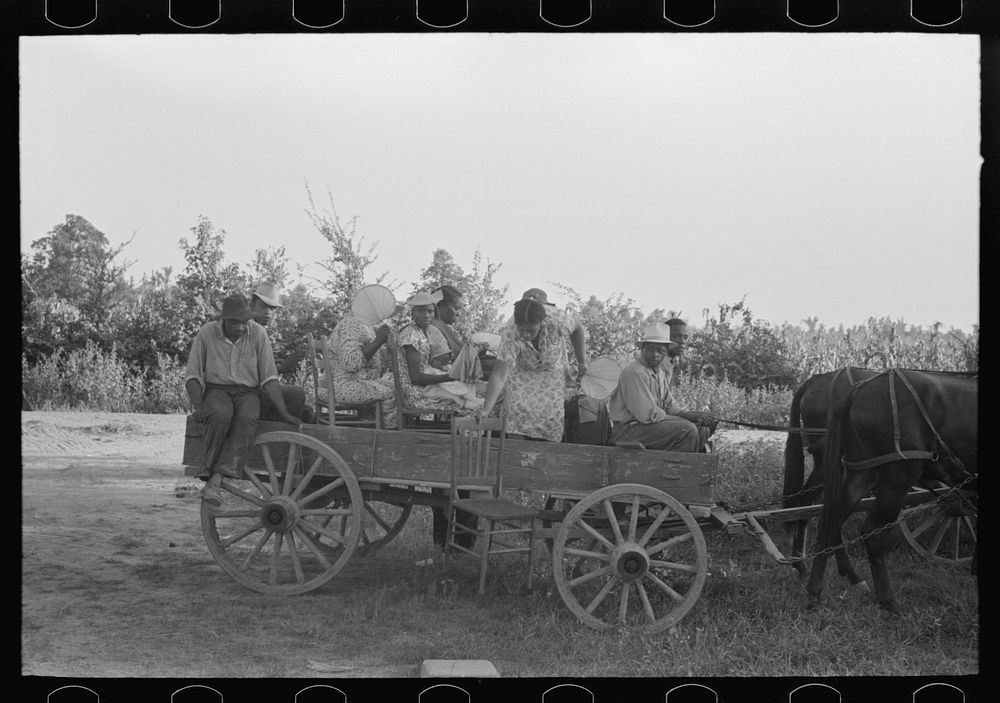  clients arriving in wagon at meeting, Southeast Missouri Farms. by Russell Lee